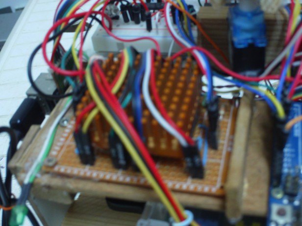this is the motor driver board; underneath this orange heatsink(that i got from an old PC) are 2 L293D ICs that control the 4 motors directions.