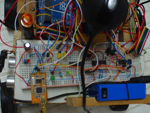this is not some messy wirings, this is ThunderWiring!!!! the blue thing is the battery(12v dc 1800mah) and the orange board is the wireless receiver(APC220) with the antenna attached to it those ICs, are shift registers! they're cool too!